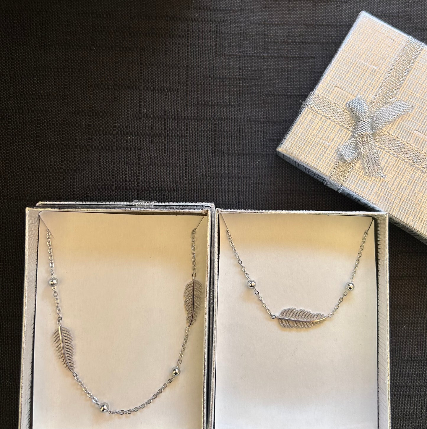 Completo collana + bracciale piuma argento in acciaio