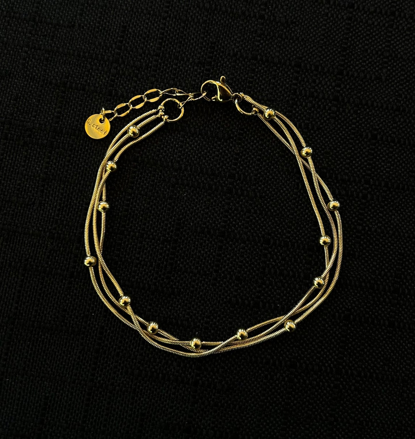 Bracciale a tre fili con palline oro in acciaio